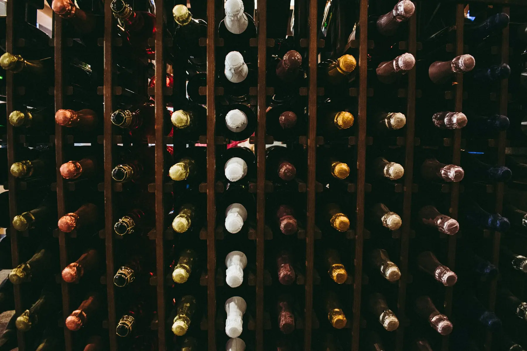 Wine bottles resting on wooden racks